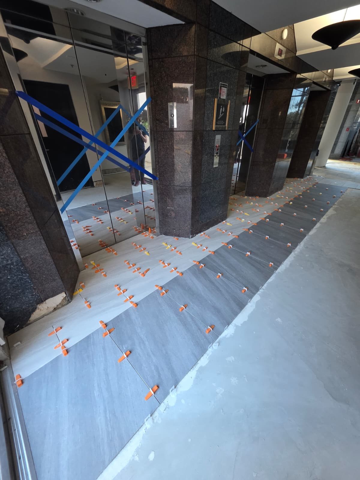 Elevator lobby with new two-tone porcelain set and clipped